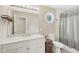 Well-lit bathroom featuring a vanity with storage, a toilet, and a shower-tub combination with a neutral shower curtain at 3713 W 98Th St, Carmel, IN 46032