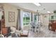 Charming dining area features a modern table, plush chair, and large window with natural light at 3713 W 98Th St, Carmel, IN 46032