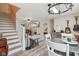 Open dining area flows to living room with guitar decor and stairs to the upper level at 3713 W 98Th St, Carmel, IN 46032