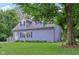 Quaint two-story home with dormer windows framed by a lush green lawn and mature trees at 3713 W 98Th St, Carmel, IN 46032