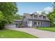 This two-story blue house features dormer windows and a detached garage at 3713 W 98Th St, Carmel, IN 46032