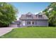 Charming two-story home boasts dormer windows, light blue siding, and a well-manicured lawn at 3713 W 98Th St, Carmel, IN 46032