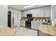 Stylish kitchen with light gray cabinets, butcher block counters, brick backsplash, and modern appliances at 3713 W 98Th St, Carmel, IN 46032
