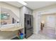 Bright kitchen features a peninsula counter, stainless refrigerator, and access to another room at 3713 W 98Th St, Carmel, IN 46032