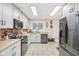 Well-lit kitchen with white cabinets, modern appliances, butcher block countertops, and brick backsplash at 3713 W 98Th St, Carmel, IN 46032