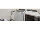Modern laundry room showcasing a sink, white cabinets, and high-efficiency washer and dryer set for convenience at 3713 W 98Th St, Carmel, IN 46032