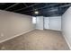 Spacious finished basement area with painted ceilings, carpeted floor and bright neutral walls at 3822 Spann Ave, Indianapolis, IN 46203