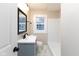 Renovated bathroom with bright white tiled walls, modern vanity and black hardware at 3822 Spann Ave, Indianapolis, IN 46203