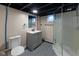 Finished basement bathroom with grey vanity, tiled shower and dark painted ceiling at 3822 Spann Ave, Indianapolis, IN 46203