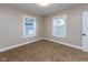 Cozy bedroom with carpeted floor, neutral walls, two windows, and white trim at 3822 Spann Ave, Indianapolis, IN 46203