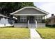 Charming bungalow with stone accents, a cozy front porch, and well-maintained lawn at 3822 Spann Ave, Indianapolis, IN 46203