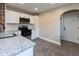 A close-up of the kitchen showing granite counters, stainless steel appliances, and a subway tile backsplash at 3822 Spann Ave, Indianapolis, IN 46203