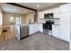 A bright and open kitchen features white cabinets, stainless steel appliances and modern countertops at 3822 Spann Ave, Indianapolis, IN 46203