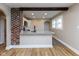 A kitchen with modern appliances, a breakfast bar, and a brick accent wall under beam at 3822 Spann Ave, Indianapolis, IN 46203