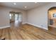 Open-concept living area with hardwood floors, neutral paint, and multiple entryways at 3822 Spann Ave, Indianapolis, IN 46203