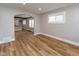 A view of the living room with wood flooring, a large window, and an archway at 3822 Spann Ave, Indianapolis, IN 46203