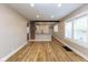 A large living room with hardwood floors, exposed beam, and natural light at 3822 Spann Ave, Indianapolis, IN 46203