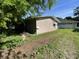 Side exterior view of home with light beige wood paneling with blue skies in background at 3908 Bertrand Rd, Indianapolis, IN 46222