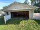 Open garage showcasing empty interior, wood beam construction, and an open door at 3908 Bertrand Rd, Indianapolis, IN 46222