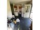 Wide view of kitchen with white appliances, dark floors, and open entryway at 3908 Bertrand Rd, Indianapolis, IN 46222