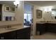 Spacious bathroom with dual vanities, dark cabinetry, light countertops, and modern fixtures at 4000 N Meridian St # Apt 11D, Indianapolis, IN 46208