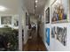 Long hallway with hardwood floors and decorative art leading to various rooms in the home at 4000 N Meridian St # Apt 11D, Indianapolis, IN 46208