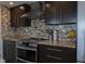 Modern kitchen features stainless steel appliances, granite countertops and stylish backsplash at 4000 N Meridian St # Apt 11D, Indianapolis, IN 46208