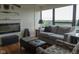 Comfortable living room features a cozy sofa, a large window, and a modern fireplace at 4000 N Meridian St # Apt 11D, Indianapolis, IN 46208