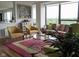 Sunlit living room offering stylish seating, contemporary art, and expansive windows with scenic views at 4000 N Meridian St # Apt 11D, Indianapolis, IN 46208