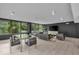 Modern lounge with a glass table, black chairs, a black couch, and large windows at 4000 N Meridian St # Apt 11D, Indianapolis, IN 46208