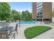Outdoor pool surrounded by lounge chairs, trees, and an apartment building at 4000 N Meridian St # Apt 11D, Indianapolis, IN 46208