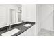 Bathroom with double vanity, gray countertops, white cabinetry, framed mirrors, and modern fixtures at 4390 Red Pine Dr, Bargersville, IN 46106