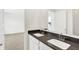 Bathroom featuring a double vanity with dark countertops and a view to the bedroom through a door at 4390 Red Pine Dr, Bargersville, IN 46106