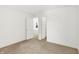 Bright bedroom features neutral carpet, white walls, and a doorway leading to another room at 4390 Red Pine Dr, Bargersville, IN 46106