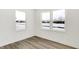 Bright bedroom featuring dual windows and light wood-look floors at 4390 Red Pine Dr, Bargersville, IN 46106