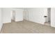 Bright bedroom showcasing neutral carpeting, white walls, and several access doors at 4390 Red Pine Dr, Bargersville, IN 46106