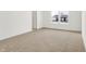 Bedroom features neutral carpet, white trim and walls, a double window and an entrance door at 4390 Red Pine Dr, Bargersville, IN 46106