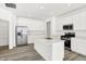 Modern kitchen featuring stainless steel appliances, white cabinets, quartz countertops, and a large center island at 4390 Red Pine Dr, Bargersville, IN 46106