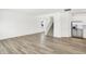 Spacious living area with modern flooring leading to a staircase and gourmet kitchen at 4390 Red Pine Dr, Bargersville, IN 46106