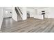 Inviting living space with modern flooring and a staircase adjacent to the gourmet kitchen at 4390 Red Pine Dr, Bargersville, IN 46106