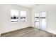 Bright living space with sliding glass doors, modern flooring, and view of backyard at 4390 Red Pine Dr, Bargersville, IN 46106