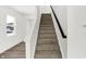 Carpeted stairs with wood railing at 4390 Red Pine Dr, Bargersville, IN 46106