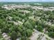 Overhead view of a residential area showcasing tree-lined streets and a mix of commercial buildings at 4926 Crittenden Ave, Indianapolis, IN 46205