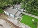 Aerial view of a home with a well-manicured lawn, mature trees, and a welcoming front porch at 4926 Crittenden Ave, Indianapolis, IN 46205