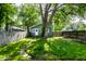 Charming backyard featuring a mature tree, a small garden area, and a well-maintained lawn at 4926 Crittenden Ave, Indianapolis, IN 46205