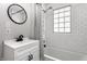 Modern bathroom features white subway tile, black fixtures, and a shower with a striped curtain at 4926 Crittenden Ave, Indianapolis, IN 46205
