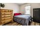 Comfortable bedroom featuring a large dresser, neutral decor, and a window for natural light at 4926 Crittenden Ave, Indianapolis, IN 46205