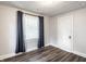 Light-filled bedroom with modern ceiling, dark wood floors, and blue curtains at 4926 Crittenden Ave, Indianapolis, IN 46205