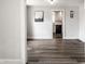 Bright room featuring hardwood floors, neutral walls, and view of an updated kitchen at 4926 Crittenden Ave, Indianapolis, IN 46205