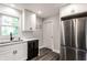 Modern kitchen boasts stainless steel refrigerator, black dishwasher, and bright natural light at 4926 Crittenden Ave, Indianapolis, IN 46205